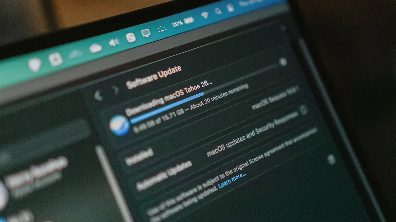 A laptop screen showing a software update downloading