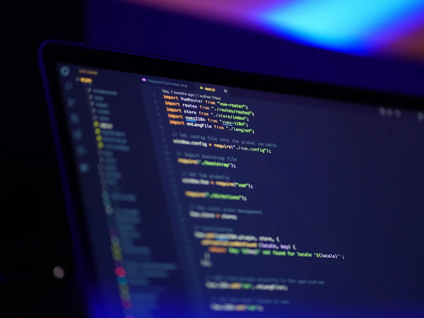 Laptop screen showing code in a dark room