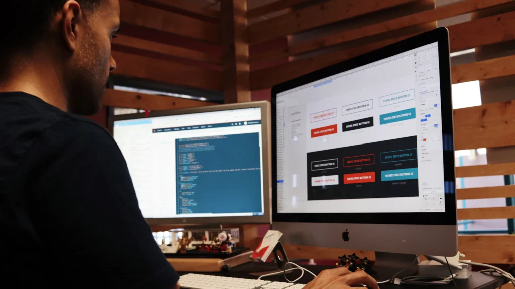 A webmaster working on a business website at a desktop computer