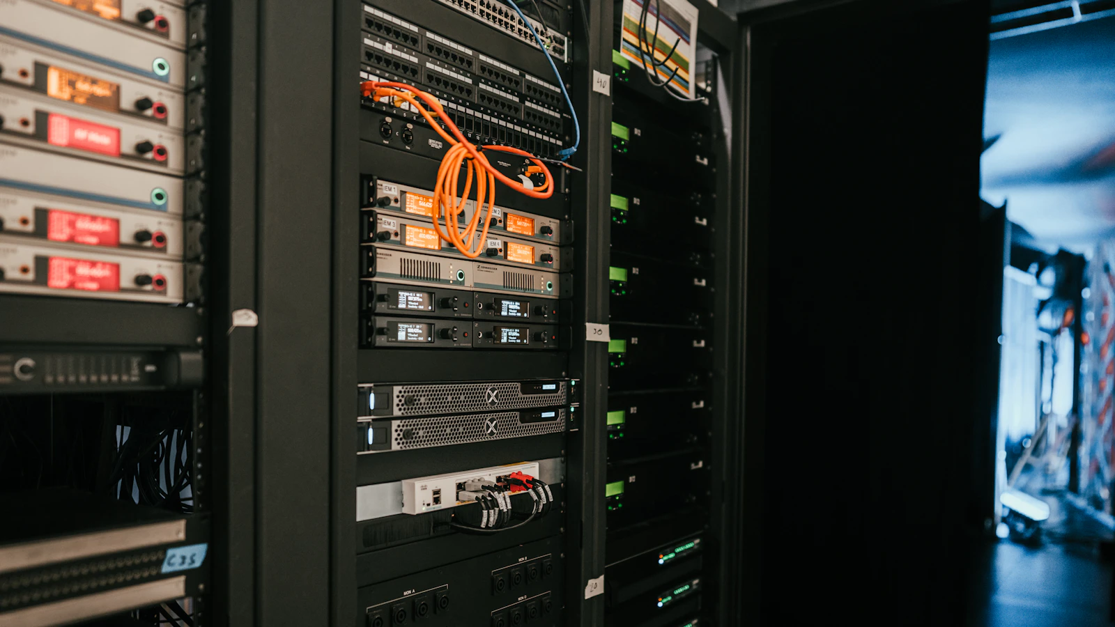 A rack of servers with network cables in a server room